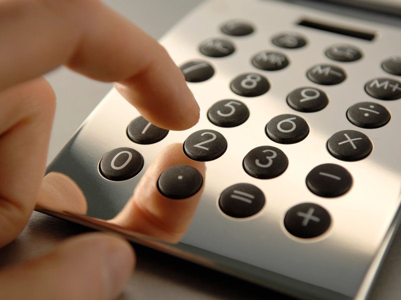 closeup of person using calculator - Big Dog Flooring in Indianapolis, IN